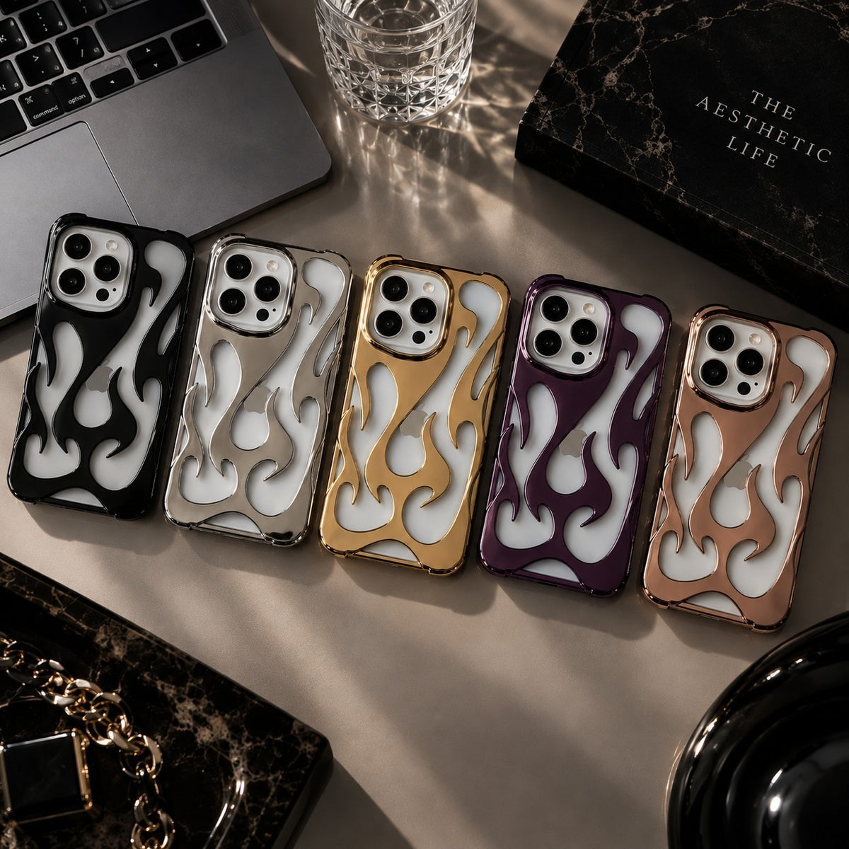 Zelpora iPhone cases featuring chrome flame designs in black, silver, gold, plum, and bronze on frosted backings.